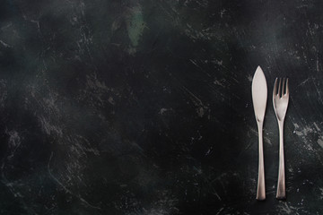 Cutlery on a dark wooden background ready to eat
