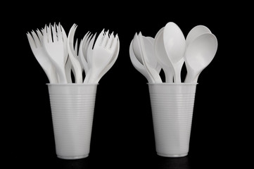 disposable plastic spoons and forks in a plastic Cup