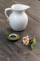 Fototapeta na wymiar white flower jar on a wooden table
