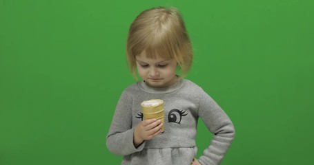 Kid girl eat ice cream on a Green Screen, Chroma Key