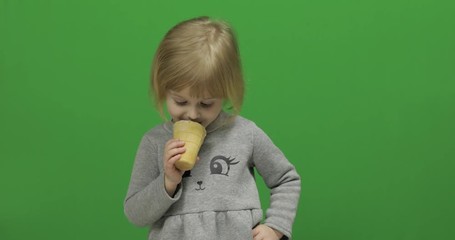 Kid girl eat ice cream on a Green Screen, Chroma Key