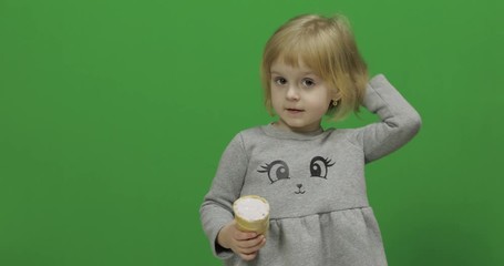 Kid girl eat ice cream on a Green Screen, Chroma Key