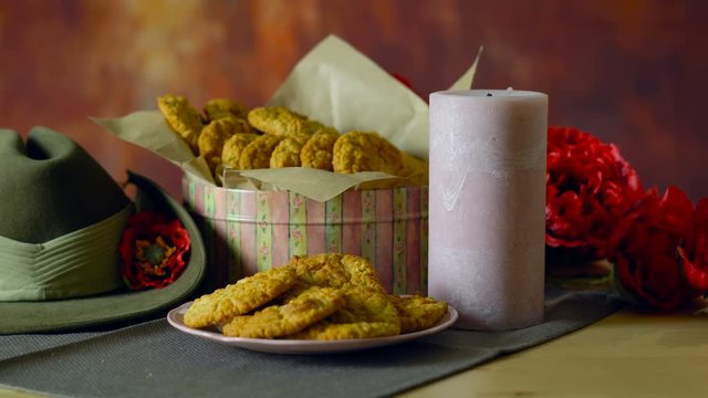 Traditional ANZAC biscuits for ANZAC Day and Remembrance Day memorial holidays in vintage style setting with Australian army slouch hat.