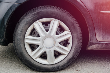 View of the wheel in the car. The concept of tire replacement, summer and winter season. Wheel with...