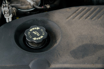 Engine oil tank under the hood of the car. Concept of car fluids care, replenishment of engine oil....
