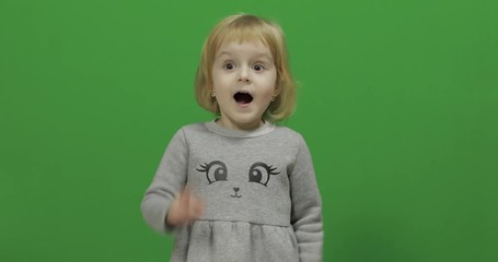 Kid girl making a fly kisses on a Green Screen, Chroma Key