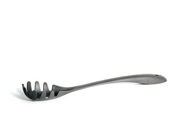 Noodle extraction spoon isolated on a white background. The concept of eating, using kitchen items while cooking. Supporting special devices during cooking, preparing a meal.