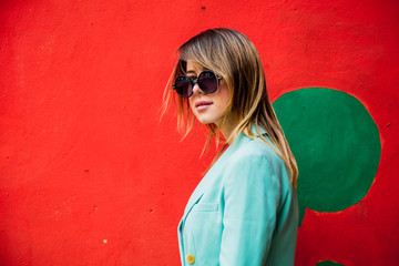 Young woman in Blazert of 90s style and sunglasses