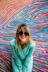 Young woman in Blazer of 90s style and sunglasses