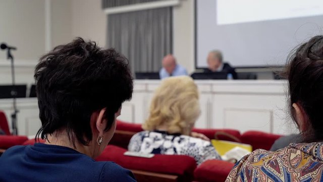 Defense of doctoral dissertation. The board members sit in the conference room. The tribune is visible.