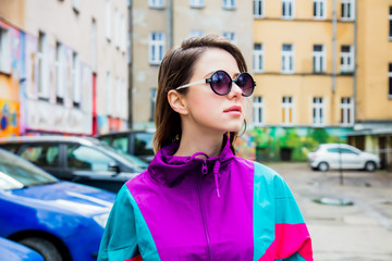Young woman in jacket of 90s style stay at  back yard