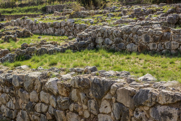 old abandoned stone wall terraces in green grass spring garden exterior natural environment