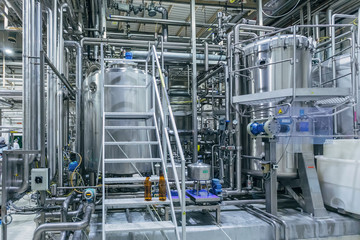 Modern brewery interior. Filtration vats, pipeline, valves and other equipment of beer production...