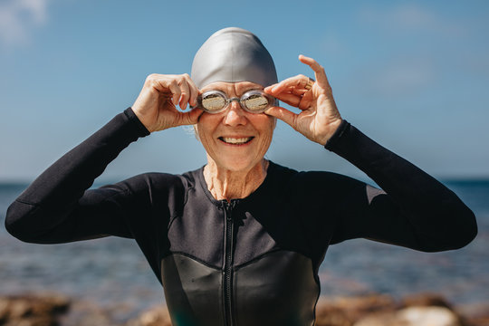 Senior Woman Enjoying A Swim At The Sea