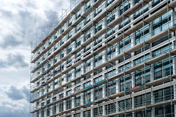  new building under construction scaffolding on house facade