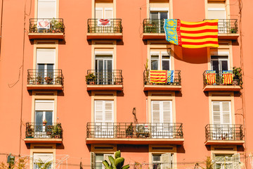 Valencia, Spain - March 16, 2019: Facade of a building with a large Señera, flag of Valencia,...