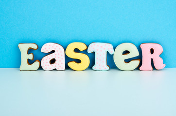 Bright Easter background.  Decoration eggs and colorful letters forming words  EASTER. Celebration concept.