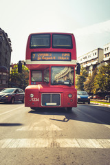 Fototapeta premium A double-decker bus driving in the city