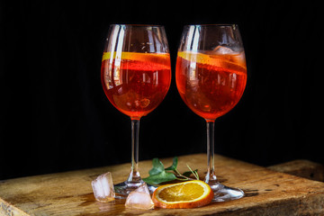 Aperol spritz cocktail in glass on wooden table