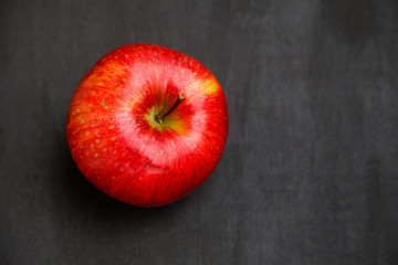 Apple on black wooden desk