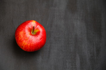 Apple on black wooden desk