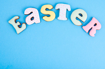 Bright Easter background.  Decoration eggs and colorful letters forming words  EASTER. Celebration concept.