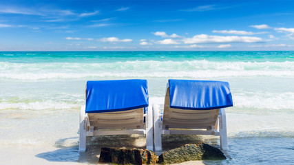 Summer vacation background. deckchairs on white sand beach and ocean sea. Travel and relax with holiday.