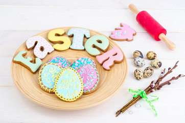 Homemade Easter pastry in shape of letters and eggs on wooden background.