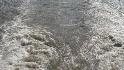 Ship wake on the river, Water foam trace behind the large ship goes, high speed camera, slow motion.
