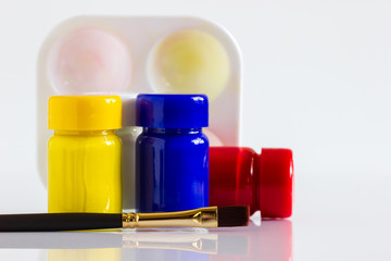 Poster colour bottle, paintbrush and palette on white background. Concept of art learning or...