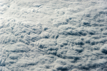 Top view of white clouds above the ground or water