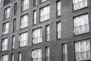 new apartment building complex with covered windows - new flats ,