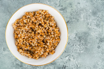 Buckwheat porridge in white plate, vegetarian dish