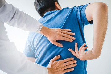 Physical Doctor consulting with patient about Back problems Physical therapy concept