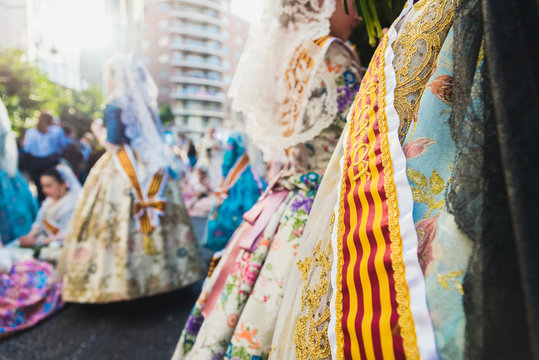 Valencia, Spain - March 17, 2019: Banda and Valencian flag decorating the typical Valencian fallera dress, worn by the beautiful women of Fallas.