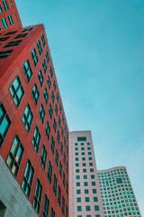 Low angle view of two corporate buildings and a hotel  on blue sky
