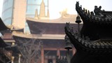 Immortal and beasts on the eaves of the building in Shanghai Jingan temple, Imperial yellow roof decorations, Wind bells under eaves sway with the wind, 4K video, slow motion. 