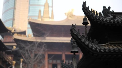 Immortal and beasts on the eaves of the building in Shanghai Jingan temple, Imperial yellow roof decorations, Wind bells under eaves sway with the wind, 4K video, slow motion. 