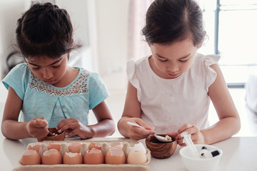 young children planting seedlings in reuse eggshells, montessori homeschool education