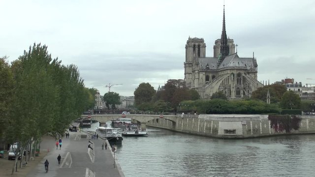 Paris, France. Pleasure boat near Notre-Dame de Paris. View from the Pont de la Tournelle.