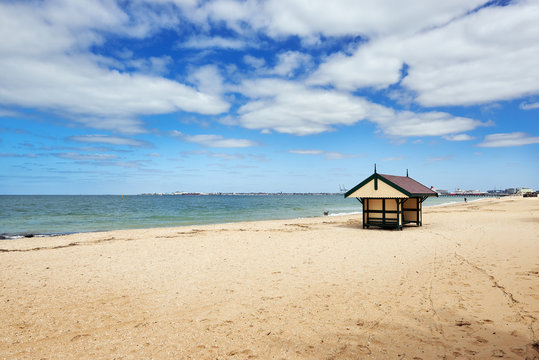 Sun shelter building on an empty Melbourne beach. © Chris Mirek Freeman