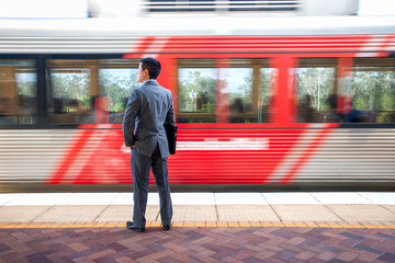 Man with files waiting near train