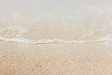 Sea wave closeup on a sandy beach