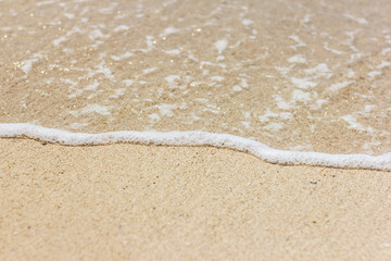 Fototapeta na wymiar Sea wave closeup on a sandy beach
