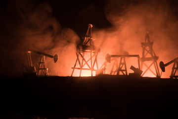 Wood Decoration. Oil pump oil rig energy industrial machine for petroleum in the sunset background...