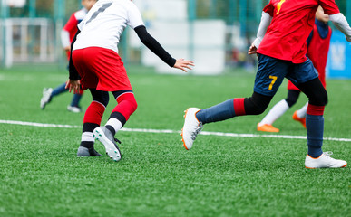 Football training soccer for kids. Boy runs kicks dribbles soccer balls. Young footballers dribble and kick football ball in game. Training, active lifestyle, sport, children activity concept 