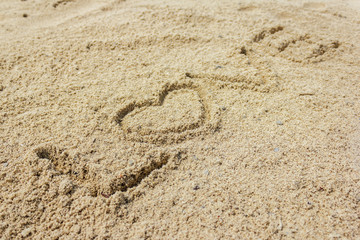 Fototapeta na wymiar Love word written on the sand at the beach, natural background of love symbol