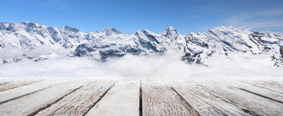 Empty wood table top and blurred snow mountain banner background - can used for display or montage your products.