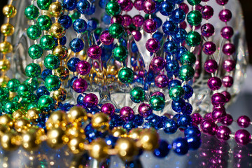 Abstract background of modern lead crystal glass reflecting color in beads with bokeh