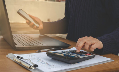 Fototapeta premium Businessman calculating cost sale analysis data.